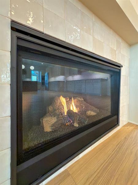 Built-in gas fireplace featuring a black metal frame and glass screen