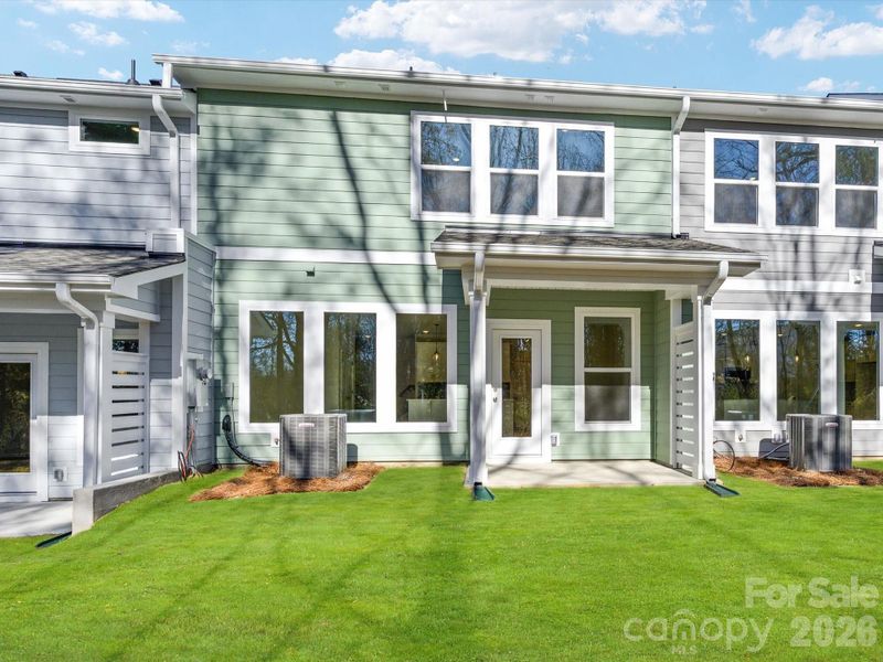 Covered back porch with wooded views