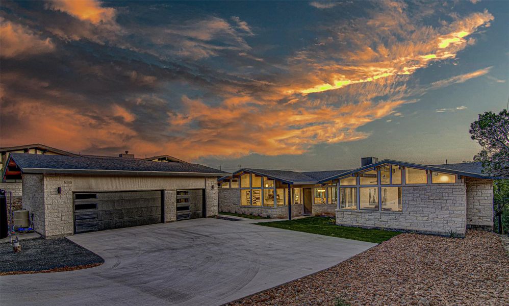 View of front of home featuring stone siding, concrete driveway, a garage, and roof with shingles View of front of home featuring stone siding, concrete driveway, a garage, and roof with shingles