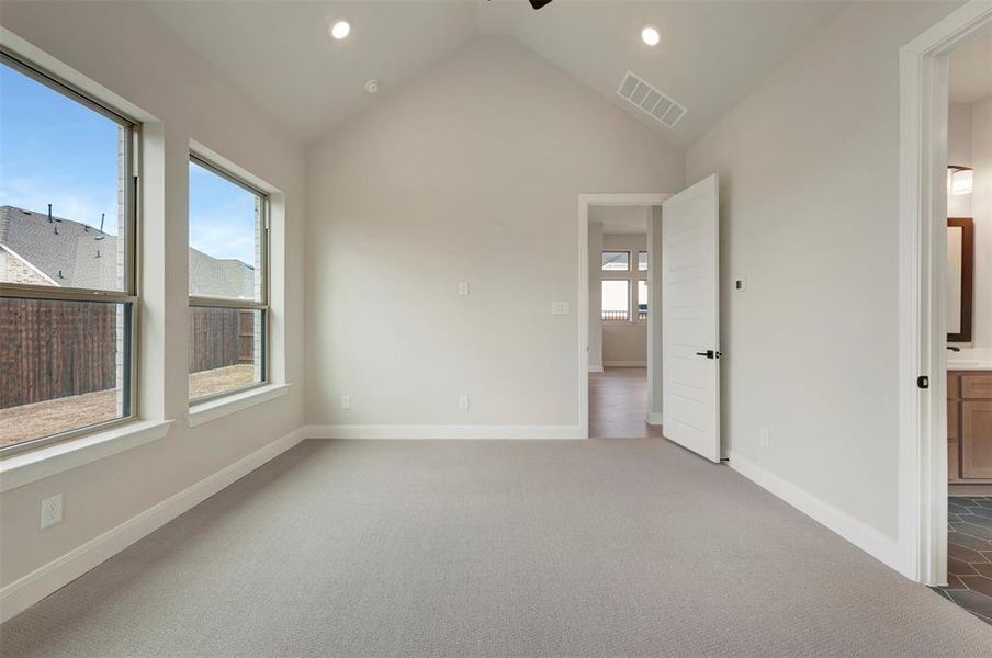 Unfurnished bedroom with carpet flooring, ceiling fan, recessed lighting, and ensuite bath