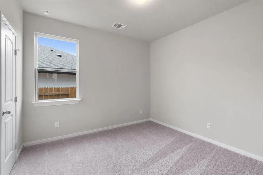 A well-lit bedroom offering a blank canvas for personalization.