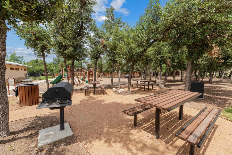 A community gathering spot for picnics and play among mature trees. A community gathering spot for picnics and play among mature trees.