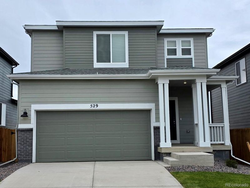 Front exterior of a new home in Lake Bluff, Greeley, CO, highlighting curb appeal (Image 1).