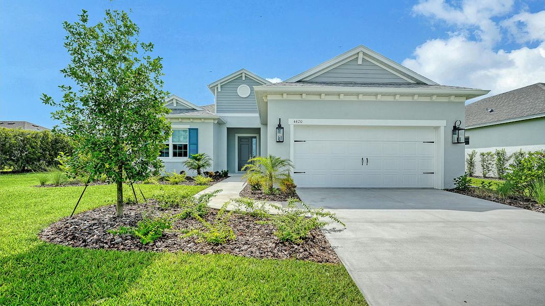 Front exterior of a new home in Canoe Creek Real Estate and Homes for Sale in Parrish, FL - Neal Communities, Parrish, FL, highlighting curb appeal (Image 1). Front exterior of a new home in Canoe Creek Real Estate and Homes for Sale in Parrish, FL - Neal Communities, Parrish, FL, highlighting curb appeal (Image 1).