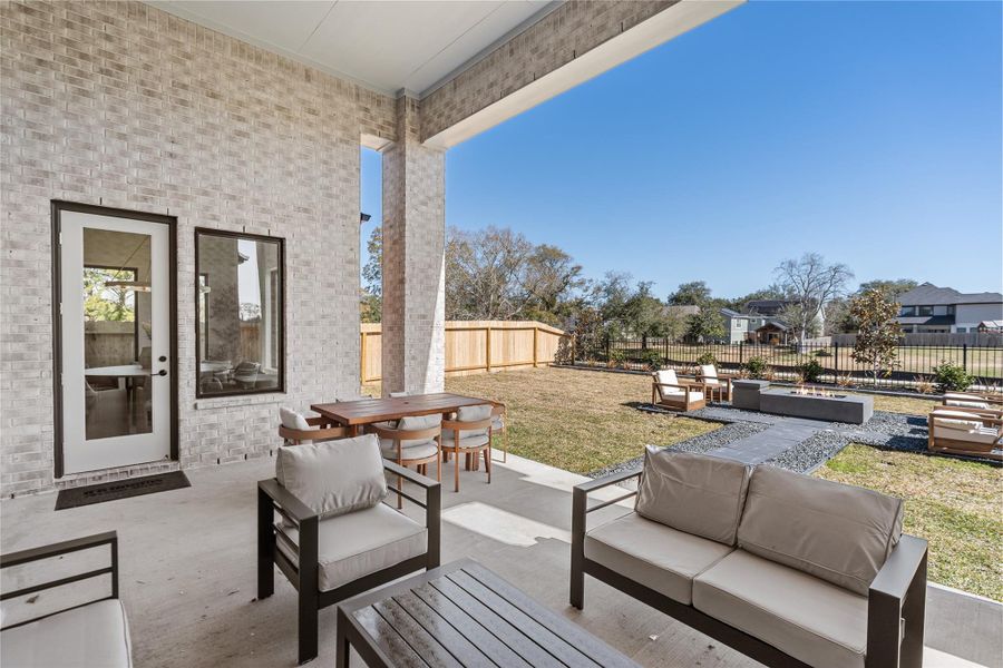 Large fenced-in backyard with a covered patio, perfect for outdoor entertaining. Large fenced-in backyard with a covered patio, perfect for outdoor entertaining.