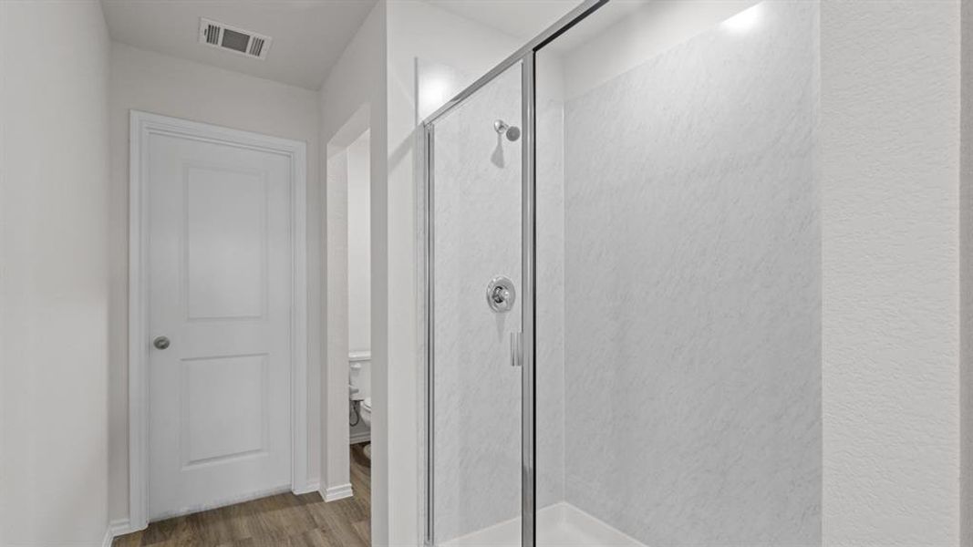 Walk-in shower with clear glass enclosure and chrome fixtures Walk-in shower with clear glass enclosure and chrome fixtures