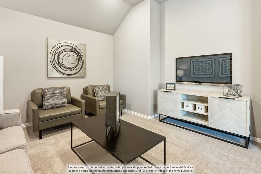 Living room with vaulted ceiling, two leather chairs, coffee table, and white media console with wall-mounted TV