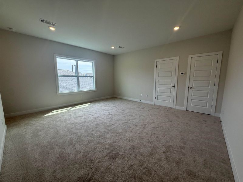 Carpeted empty room featuring baseboards and recessed lighting