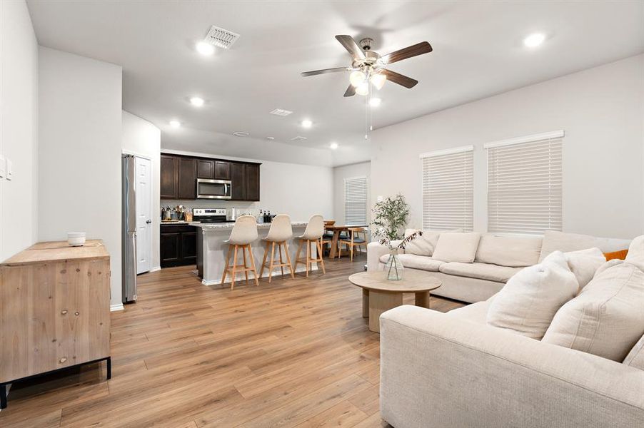 Living area with recessed lighting, light wood-type flooring, and ceiling fan Living area with recessed lighting, light wood-type flooring, and ceiling fan
