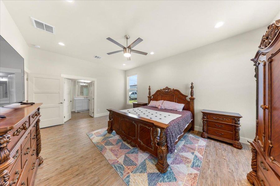 Bedroom featuring light wood finished floors, recessed lighting, and a ceiling fan Bedroom featuring light wood finished floors, recessed lighting, and a ceiling fan