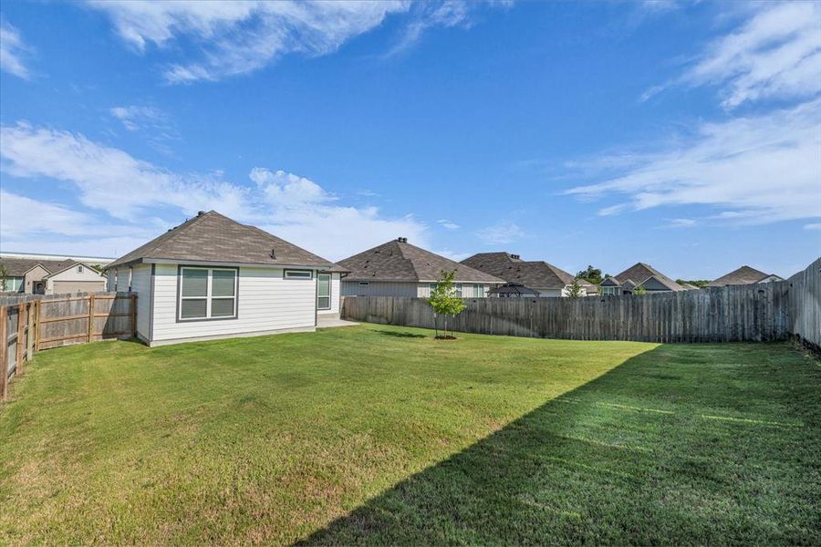 Fenced backyard featuring a residential view Fenced backyard featuring a residential view