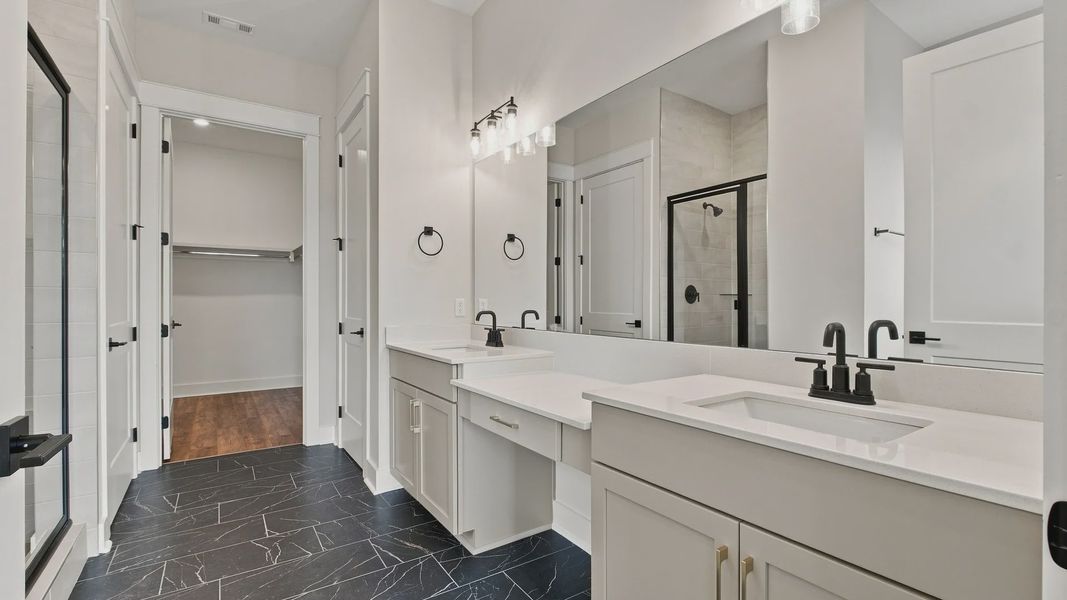 Elevated style bathroom with large mirror and dual vanity/sinks.