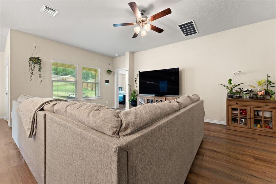 Living room with wood finished floors and ceiling fan