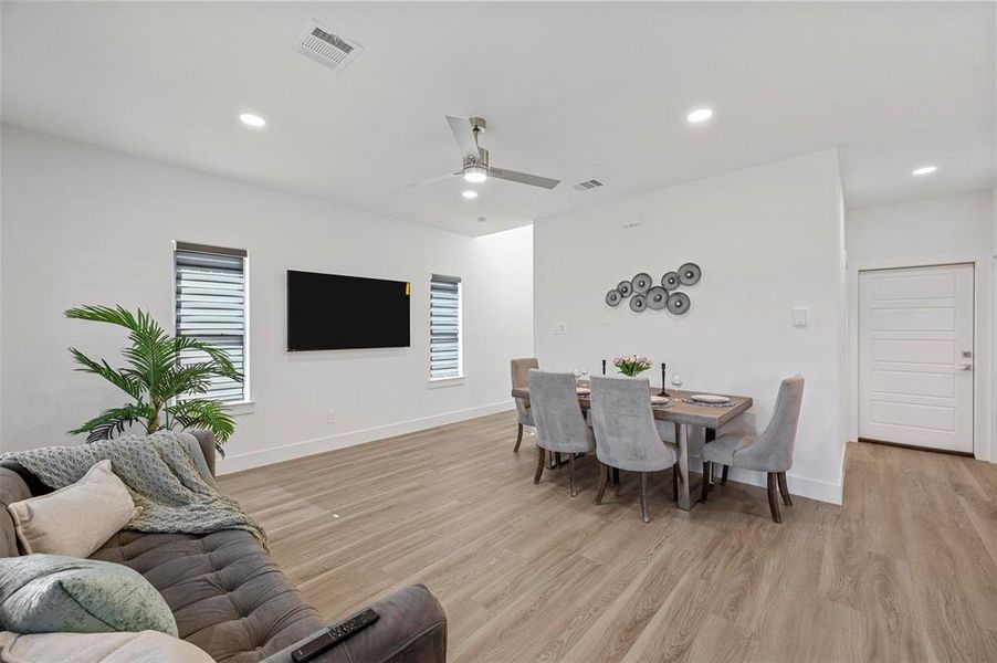 Dining room featuring baseboards, visible vents, and light wood-style floors