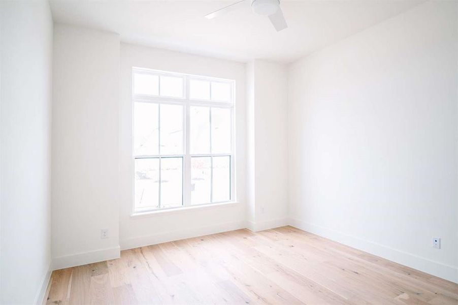 Spare room featuring ceiling fan and light hardwood / wood-style floors