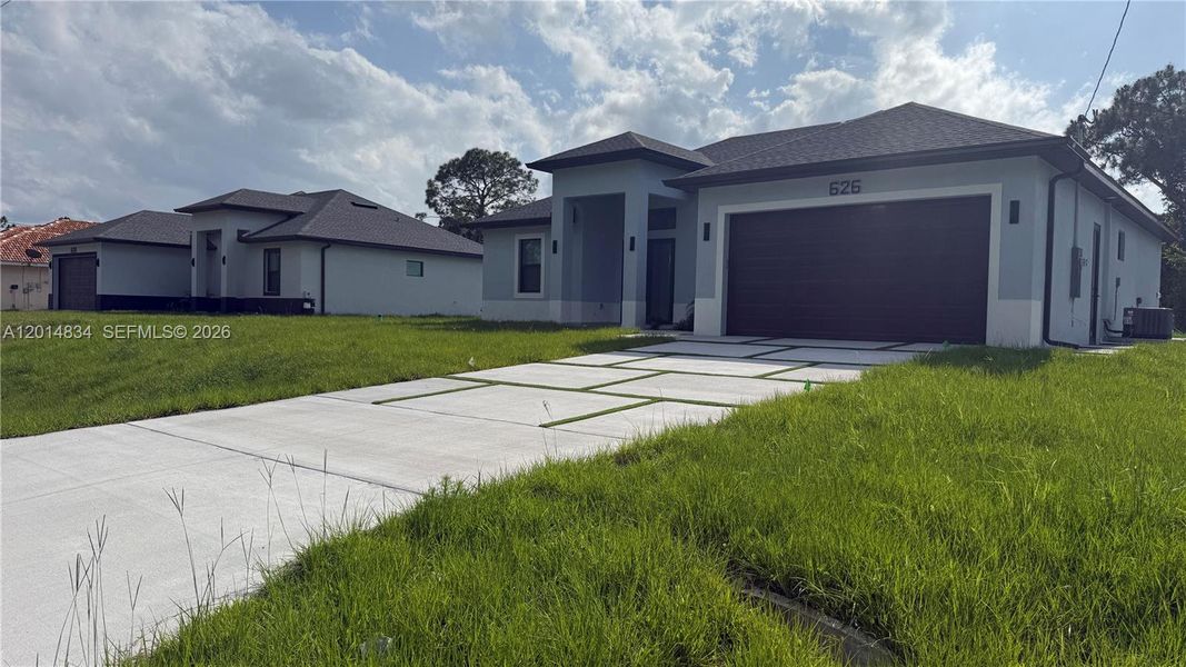 Front exterior of a new home in , Lehigh Acres, FL, highlighting curb appeal (Image 34).