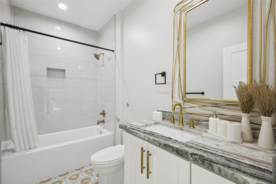 Bathroom featuring vanity, shower / tub combo, and recessed lighting