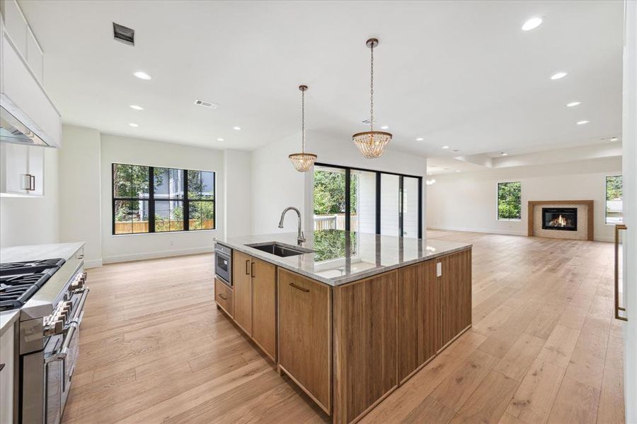 Open to the breakfast room and living room, the kitchen is the perfect gathering space for meals with family or friends. A large walk-in pantry adds convenience and ample storage, enhancing the kitchen’s functionality and appeal.