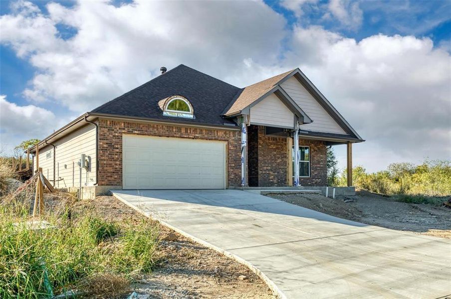 Front exterior of a new home in , Runaway Bay, TX, highlighting curb appeal (Image 12).