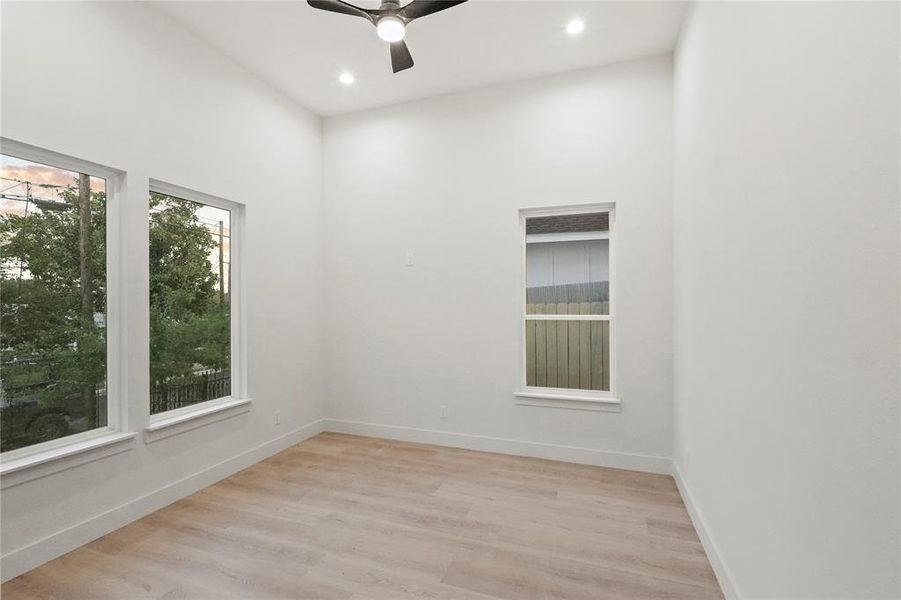 Spare room featuring ceiling fan and light hardwood / wood-style floors