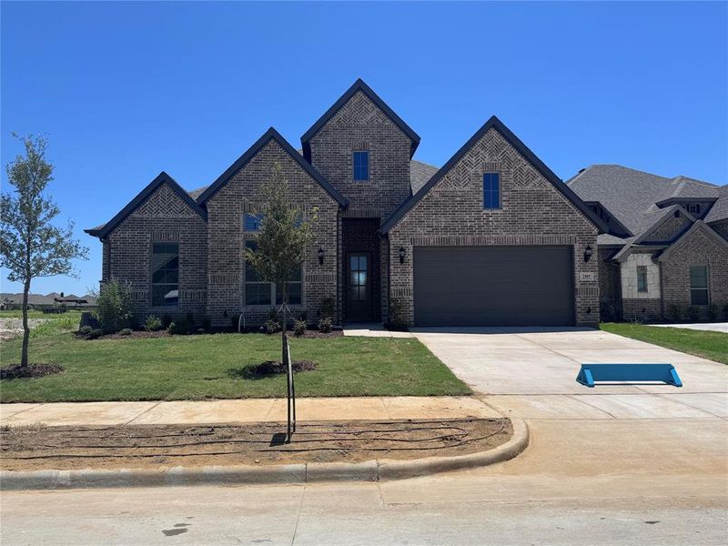 Front exterior of a new home in Somerset - Phase 5, Mansfield, TX, highlighting curb appeal (Image 2). Front exterior of a new home in Somerset - Phase 5, Mansfield, TX, highlighting curb appeal (Image 2).