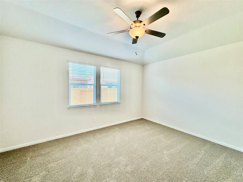 Carpeted spare room with lofted ceiling and ceiling fan Carpeted spare room with lofted ceiling and ceiling fan