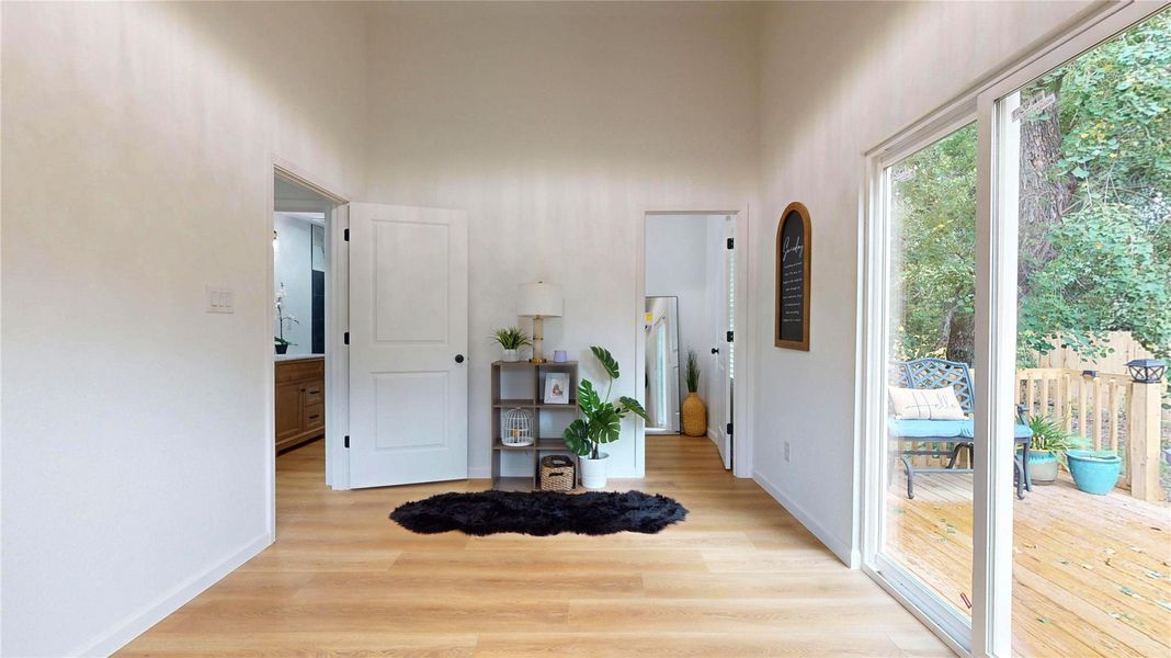 Primary bedroom with sliding glass doors to private back deck