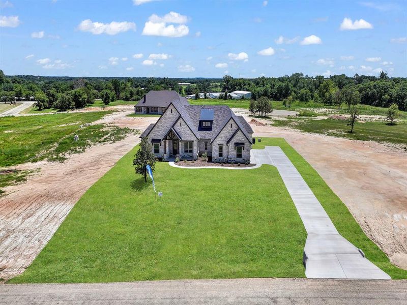 Front exterior of a new home in , Weatherford, TX, highlighting curb appeal (Image 23).