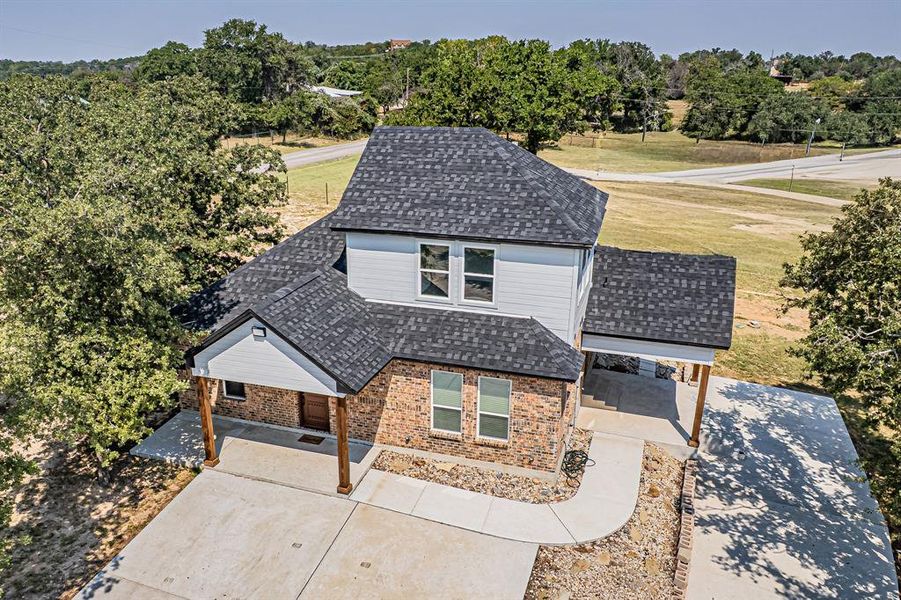 Aerial view of property and surrounding area featuring a tree filled landscape Aerial view of property and surrounding area featuring a tree filled landscape