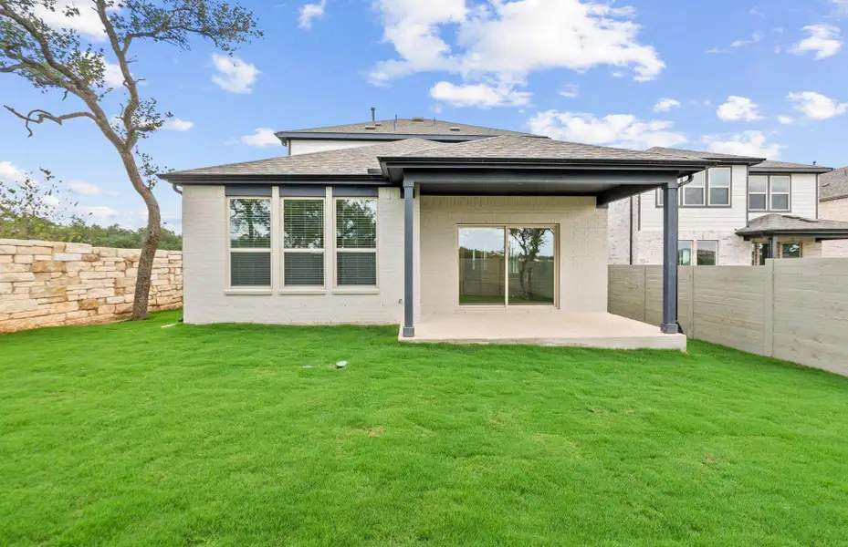 Front exterior of a new home in Wolf Ranch, Georgetown, TX, highlighting curb appeal (Image 1).
