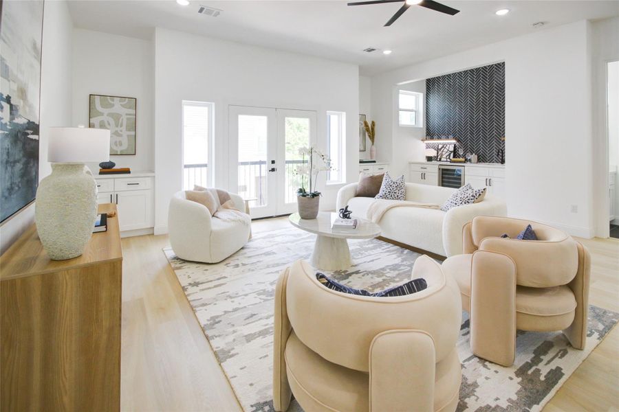 Stunning living room offers tons of natural light, wet bar, high ceilings, and ample space. Stunning living room offers tons of natural light, wet bar, high ceilings, and ample space.