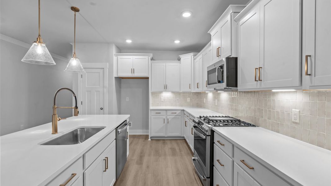First-rate kitchen with functional layout, designer pendant lighting, and a large center island First-rate kitchen with functional layout, designer pendant lighting, and a large center island