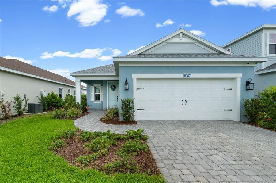 Front exterior of a new home in Wildleaf at North River Ranch, Parrish, FL, highlighting curb appeal (Image 2). Front exterior of a new home in Wildleaf at North River Ranch, Parrish, FL, highlighting curb appeal (Image 2).