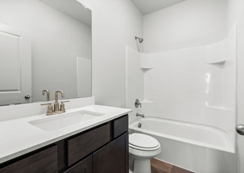 The secondary bathroom has a spacious vanity and a shower-tub combo. The secondary bathroom has a spacious vanity and a shower-tub combo.