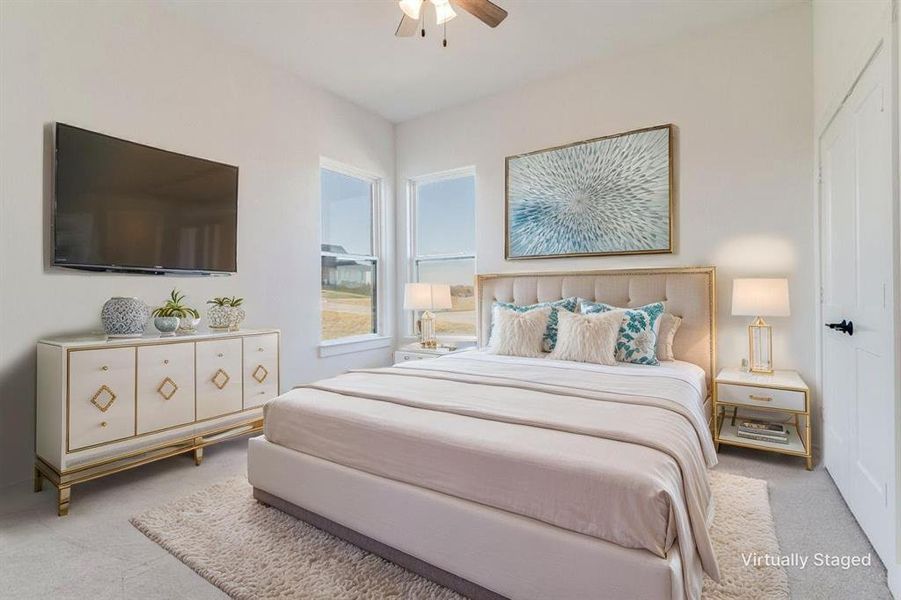 Carpeted bedroom featuring a ceiling fan