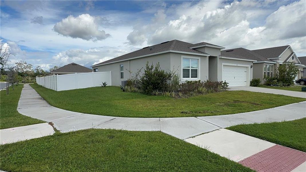 Front exterior of a new home in , Kissimmee, FL, highlighting curb appeal (Image 20).