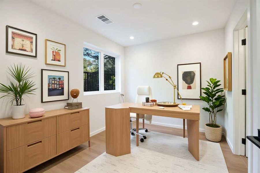 Office featuring light wood finished floors and recessed lighting