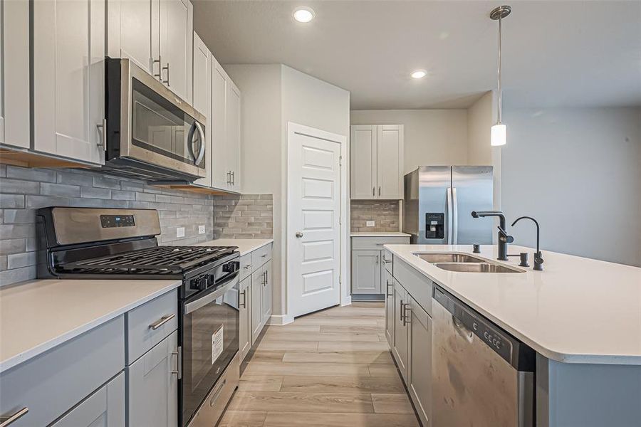 Brand new stainless steel appliances throughout the kitchen.