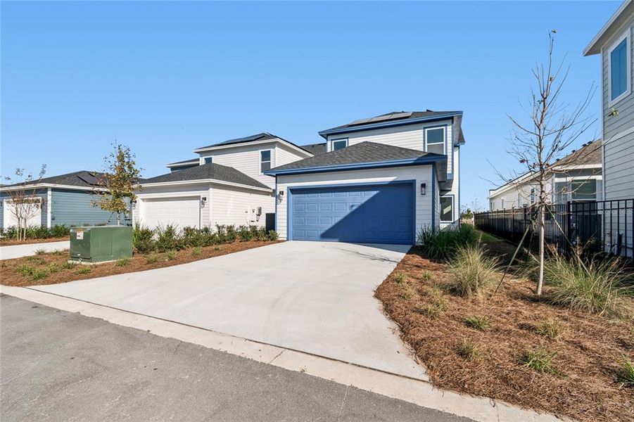 Front exterior of a new home in Weslyn Park in Sunbridge 34', St. Cloud, FL, highlighting curb appeal (Image 26).