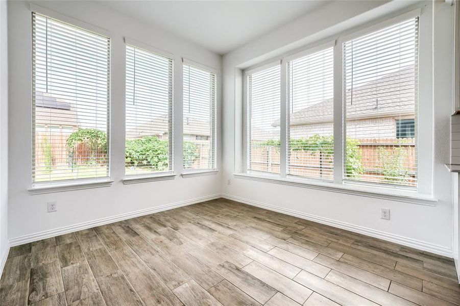 Spare room featuring baseboards and light wood-style floors Spare room featuring baseboards and light wood-style floors