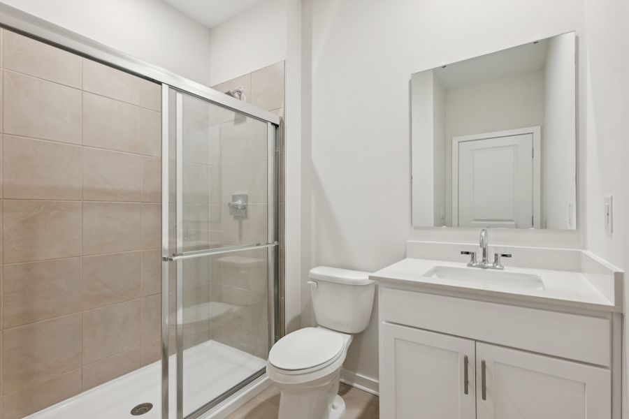 A bathroom with a glass shower. A bathroom with a glass shower.