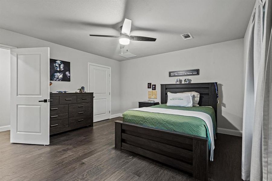 Bedroom with dark wood-style flooring and ceiling fan Bedroom with dark wood-style flooring and ceiling fan