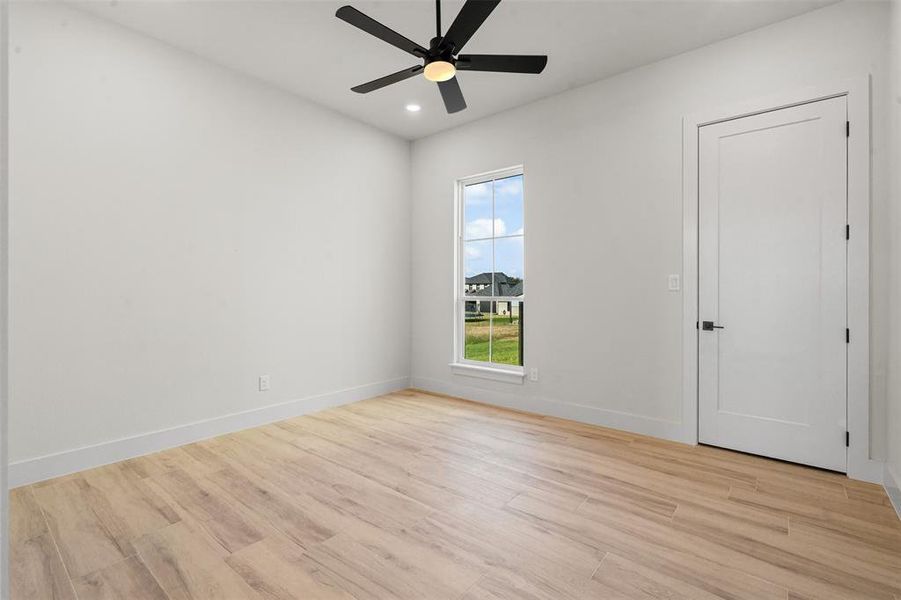 Unfurnished room featuring light wood-type flooring, recessed lighting, and a ceiling fan Unfurnished room featuring light wood-type flooring, recessed lighting, and a ceiling fan