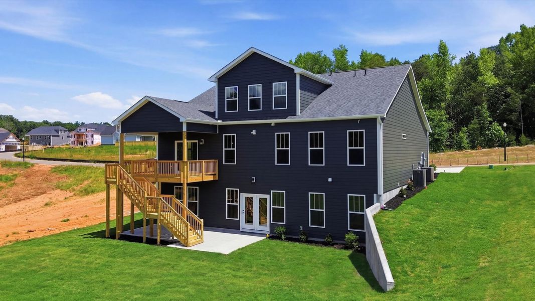 Notable exterior includes a rear covered porch and deck designed for year-round enjoyment in Woodruff, SC