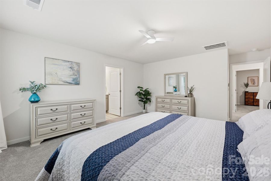 primary bedroom, walk in closet, ensuite with walk in shower, water closet, and linen closet.