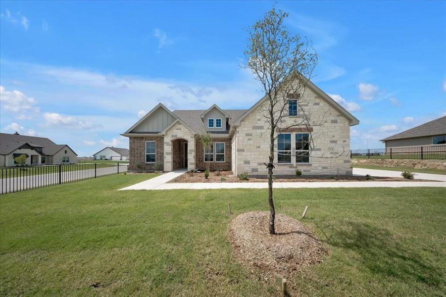 View of front of house featuring board and batten siding, brick siding, and stone siding View of front of house featuring board and batten siding, brick siding, and stone siding