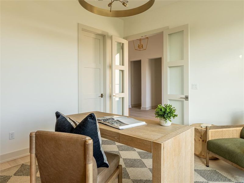 Office featuring a chandelier and light wood-style flooring