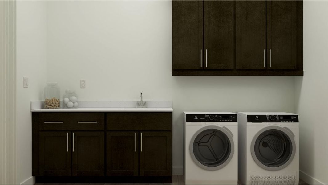 Summit laundry room with cabinetry. Washer and dryer shown.