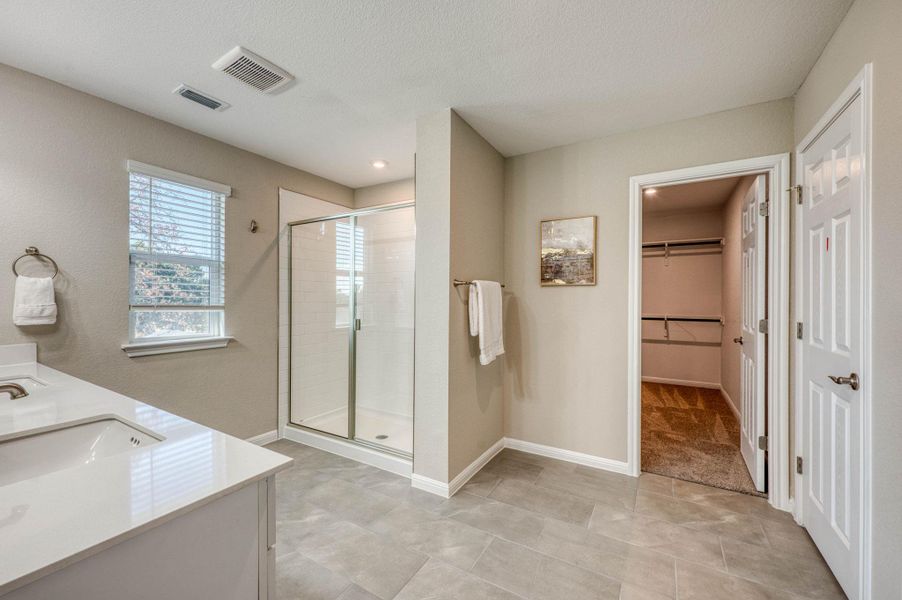 Clean lines and stone counters highlight this modern bathroom with an adjacent walk-in closet. Clean lines and stone counters highlight this modern bathroom with an adjacent walk-in closet.