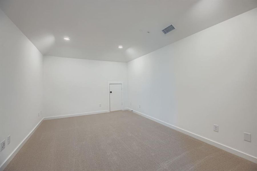 Carpeted empty room featuring baseboards and recessed lighting
